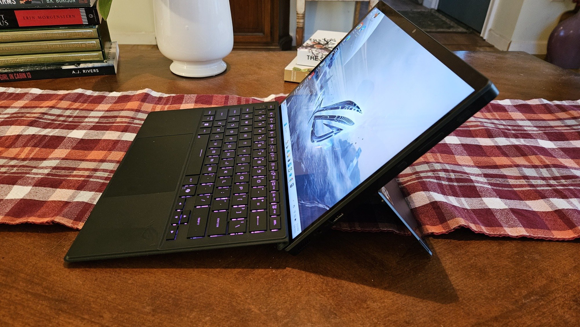 A side view of the Asus Rog Flow Z13 gametablet with the keyboard attached to a table
